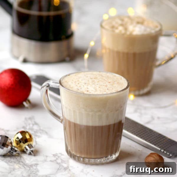 Easy Eggnog Latte Recipe Two eggnog lattes in clear glass mugs