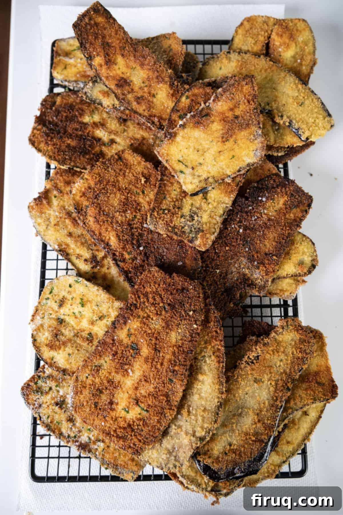 Eggplant Parmesan Sandwich 8 Fried eggplant on a cooling rack.