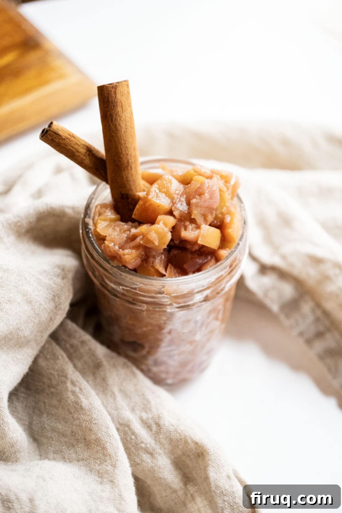 Fireside Apple Relish 2 Spiced apple chutney in a mason jar garnished with cinnamon sticks.