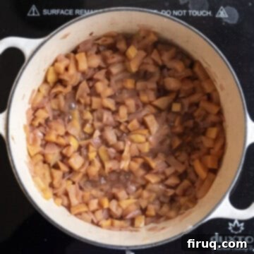 Fireside Apple Relish 8 Apples halfway through simmering in dutch oven softening.