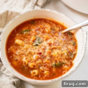 Hearty Italian Pasta and Bean Soup 13 Pasta fagiolo topped with parmesan in a bowl.