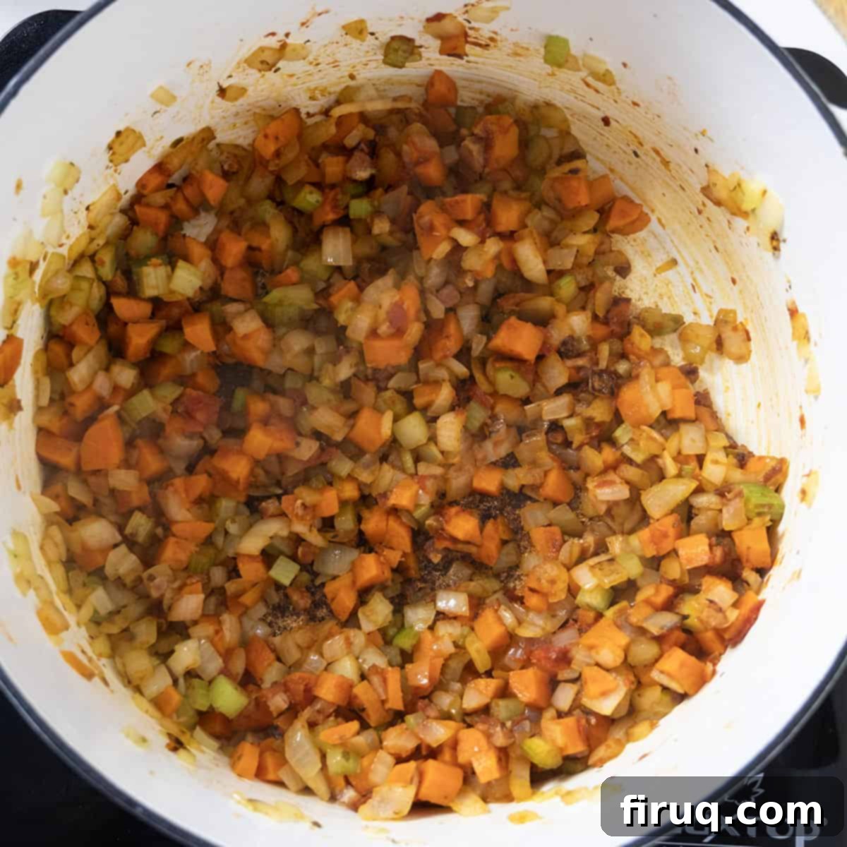 Hearty Italian Pasta and Bean Soup 6 carrots, onions, and celery combined with tomato paste in the dutch oven.