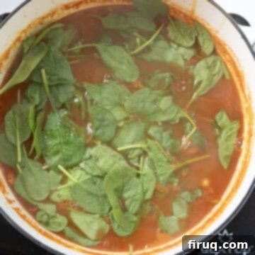 Hearty Italian Pasta and Bean Soup 10 Spinach added on top of the soup in the dutch oven.