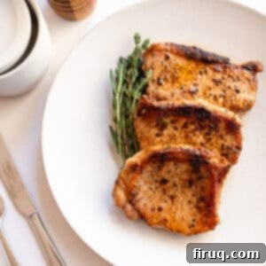 Crispy, Juicy Cast Iron Boneless Pork Chops 10 Boneless pork chops cooked on a plate with rosemary and thyme