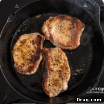 Crispy, Juicy Cast Iron Boneless Pork Chops 7 Searing pork chops on a cast iron flipped over.
