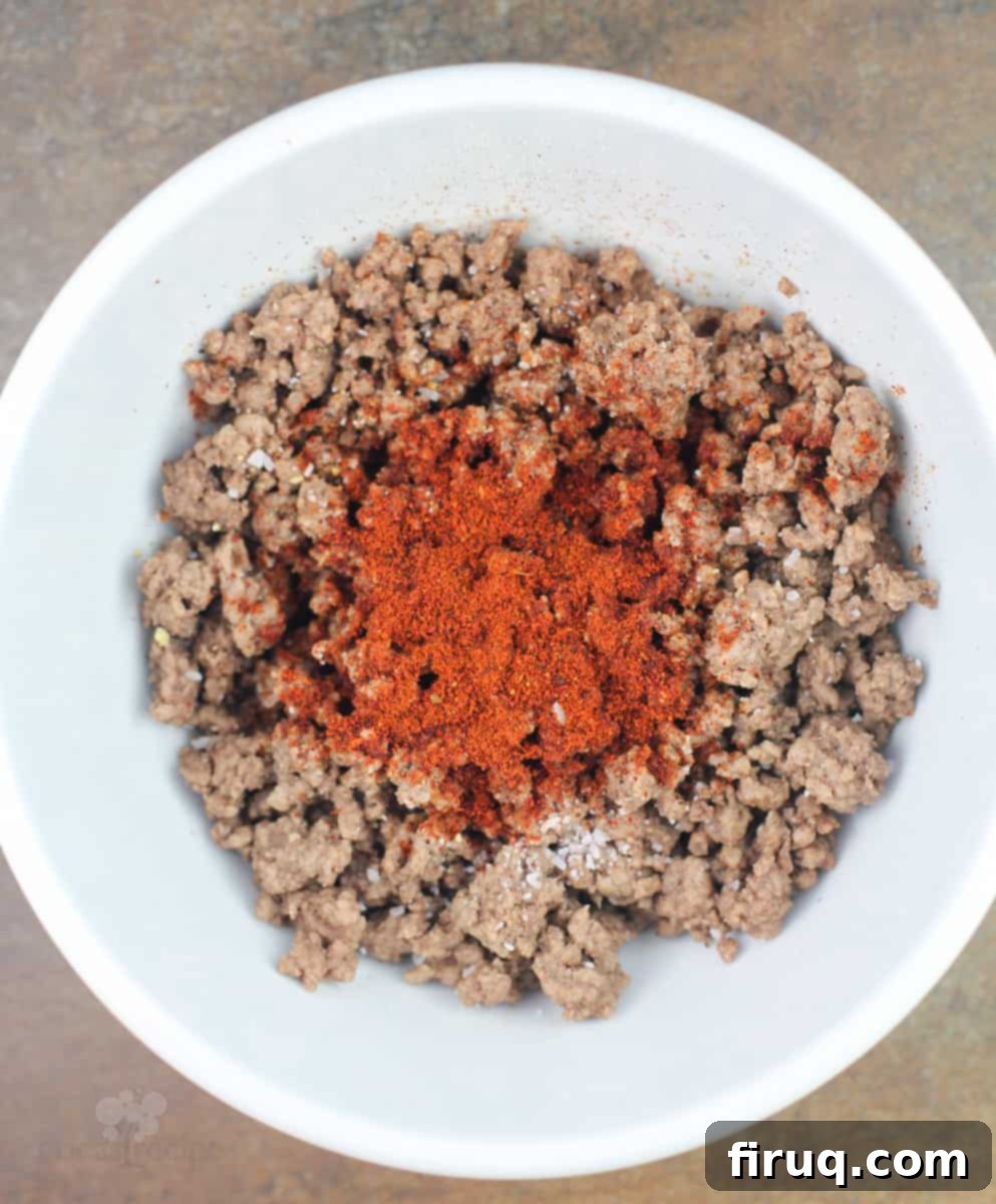 Chili Cheeseburger Pizza 5 ground beef in white bowl with chili powder