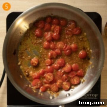 Effortless Eggplant and Tomato Pasta 8 Cherry tomatoes breaking down in a pan and wine sauce thickening.