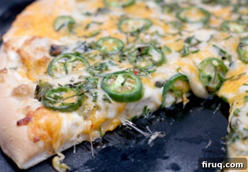 Popper's Paradise Pie 8 side view of the finished jalapeno pizza, sliced to show the cooked toppings and melty cheese