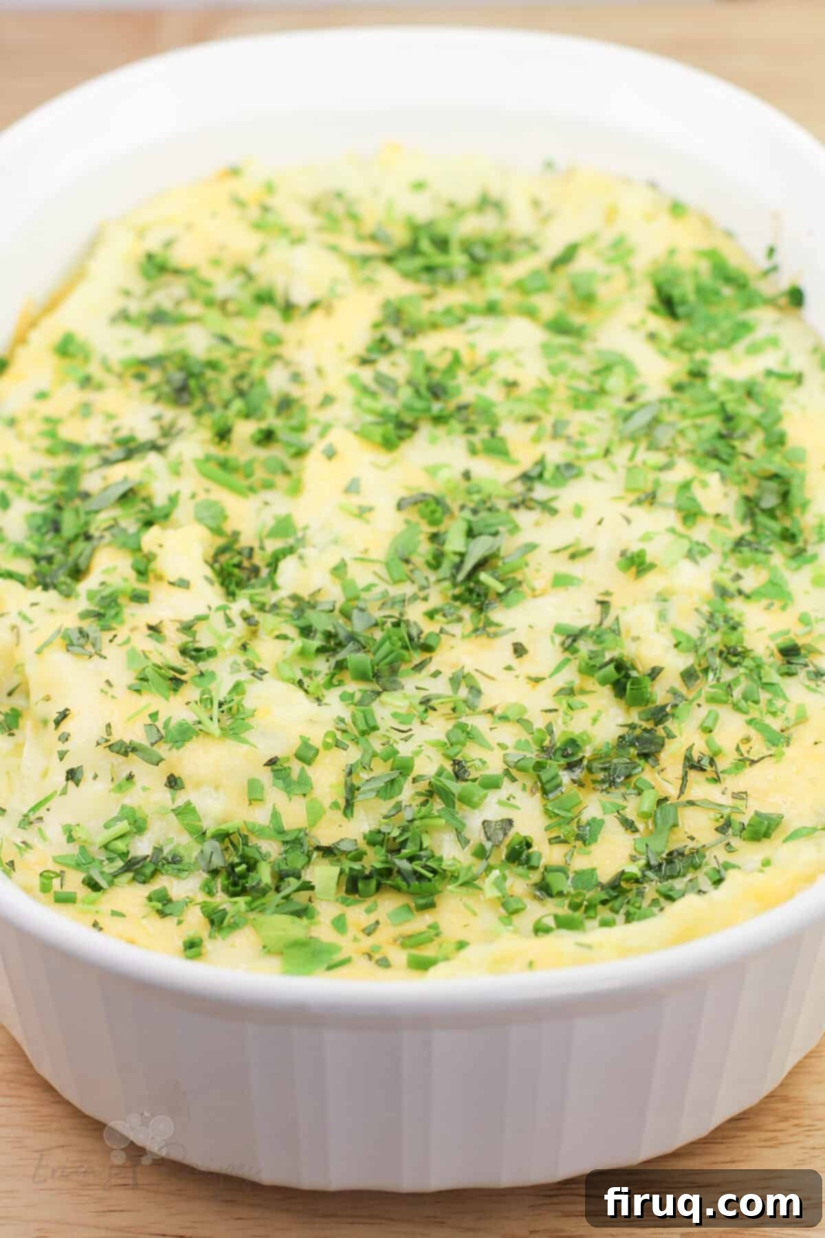Garlicky Gruyere and Gouda Mashed Potatoes 2 top, angled view into white dish of prepared guyere, garlic, and gouda mashed potatoes