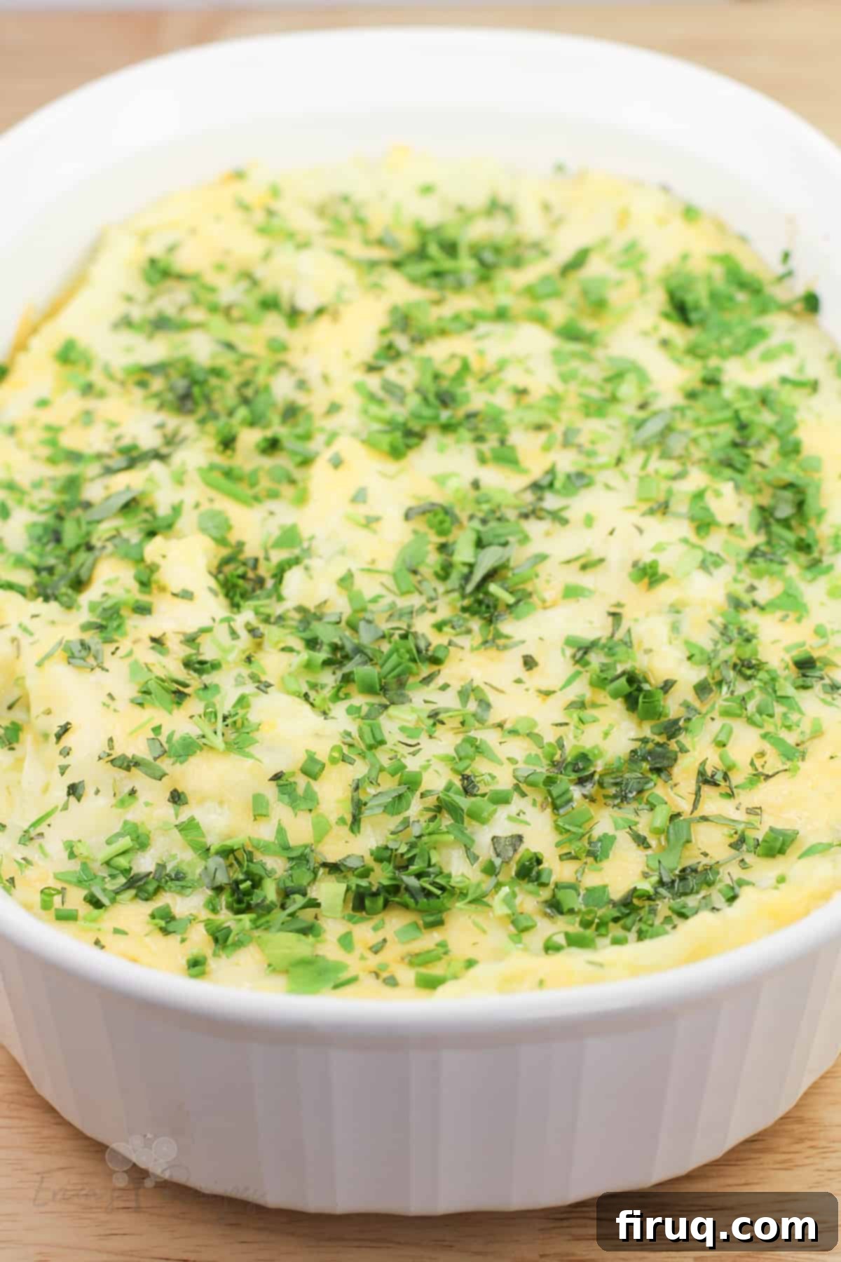 Garlicky Gruyere and Gouda Mashed Potatoes 15 top, angled view into white dish of prepared guyere, garlic, and gouda mashed potatoes