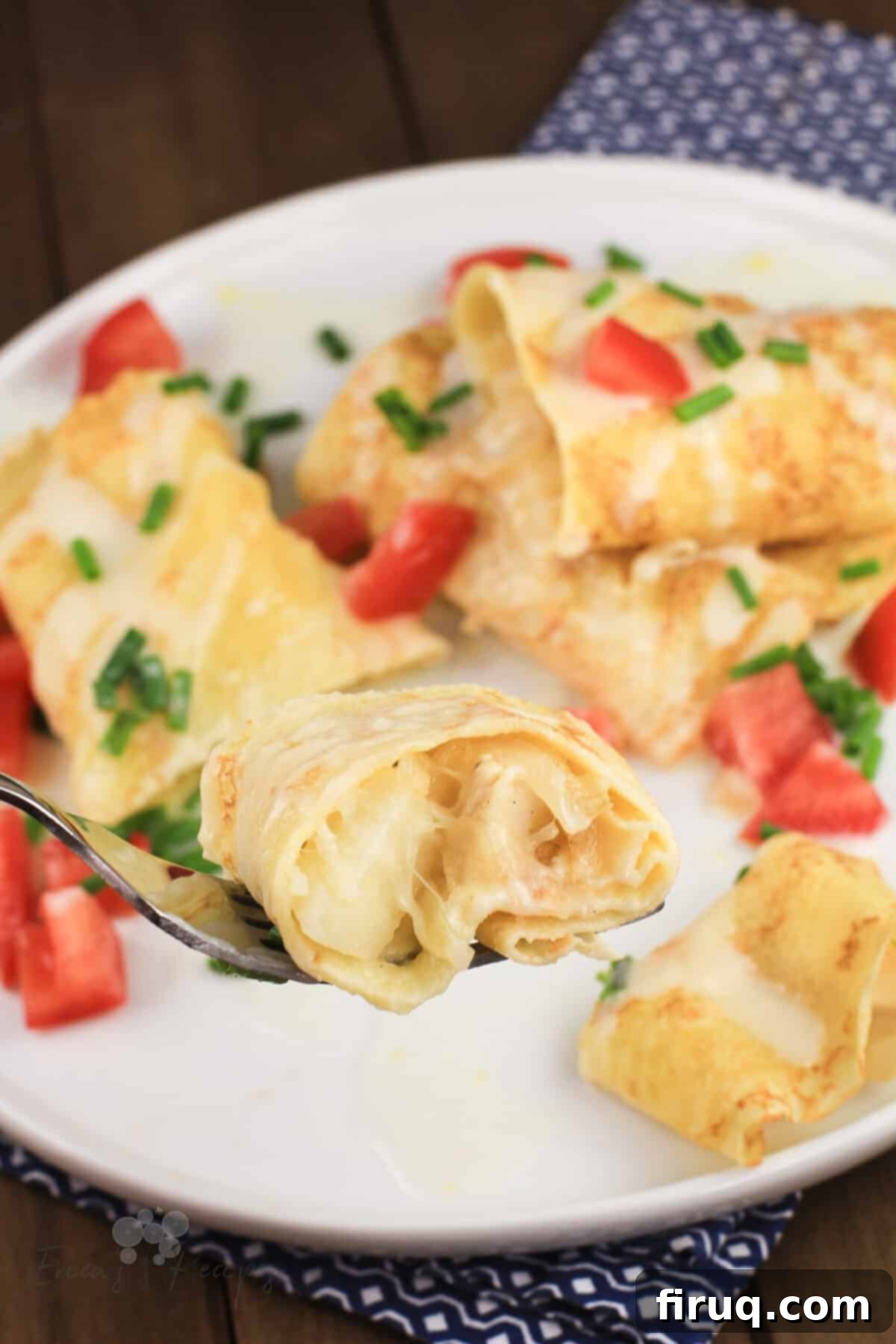 Golden Chicken Potato Crepe Parcels 3 fork holding a bite of crepes with chicken and potato