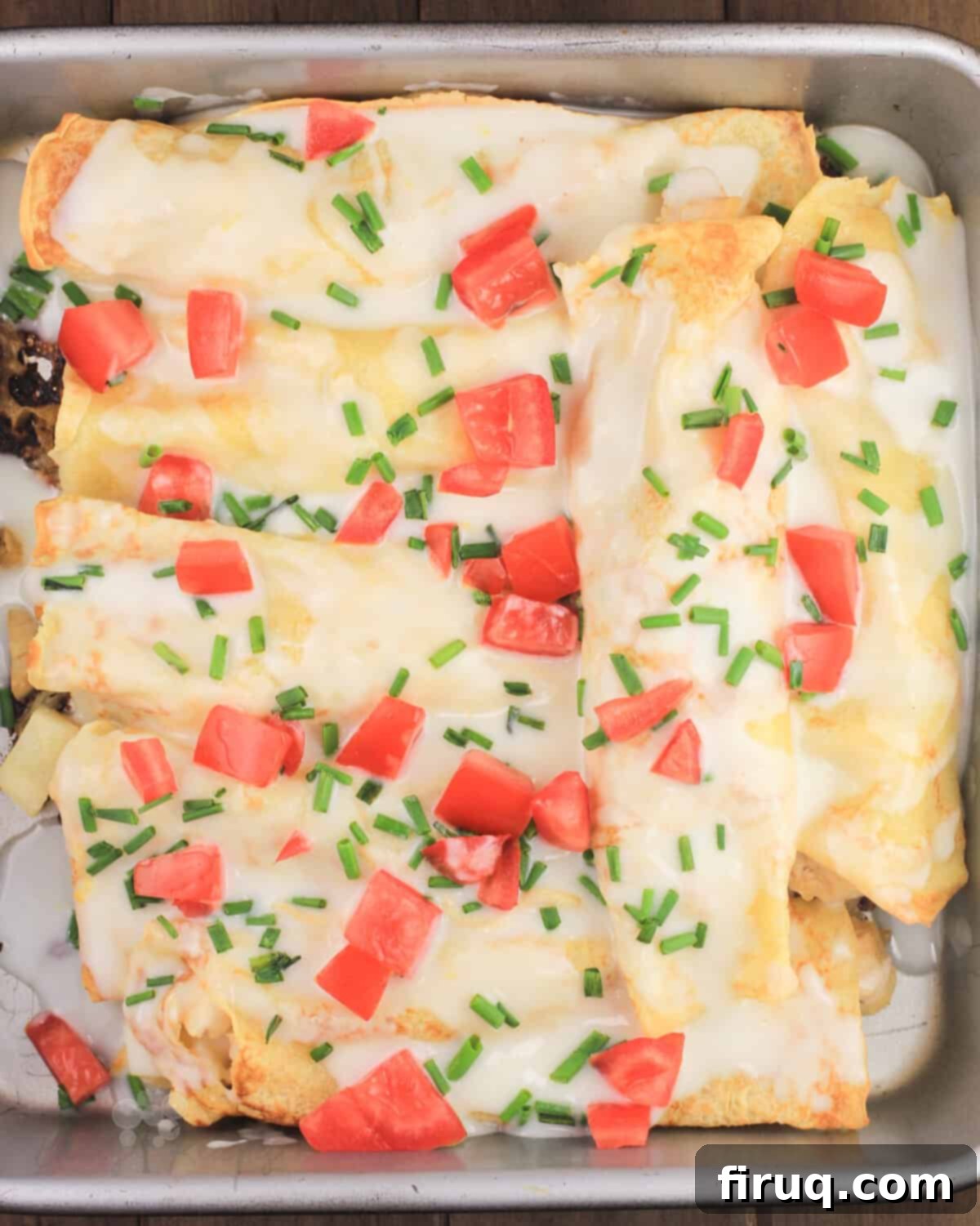 Golden Chicken Potato Crepe Parcels 10 crepes in bake pan covered with lemon bechamel sauce, tomato, and chives