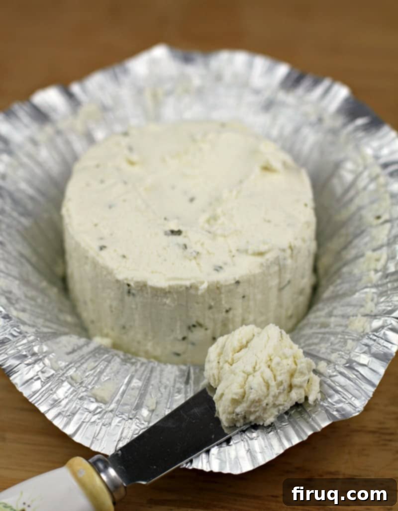 Gourmet Prosciutto-Wrapped Boursin Chicken 5 boursin cheese sitting on open foil with a butter knife