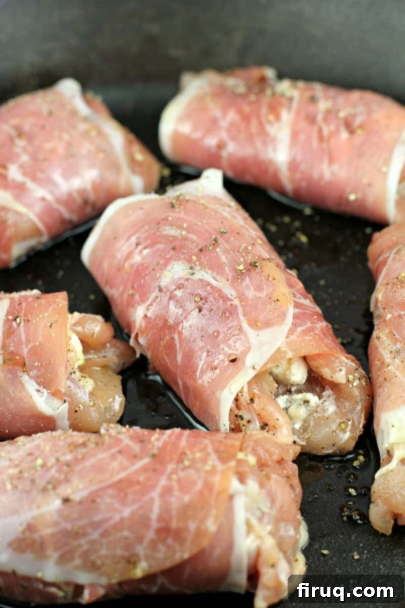Gourmet Prosciutto-Wrapped Boursin Chicken 7 assembled boursin-stuffed chicken, wrapped with prosciutto, in a cook pan