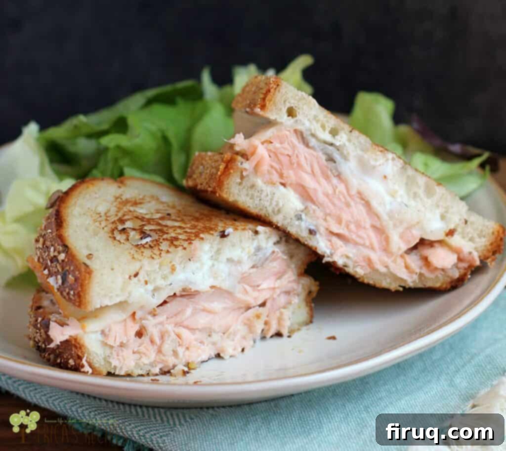 Ultimate Salmon Melt 2 A perfectly toasted salmon melt sandwich with fresh salmon and melty cheese, ready to be enjoyed.