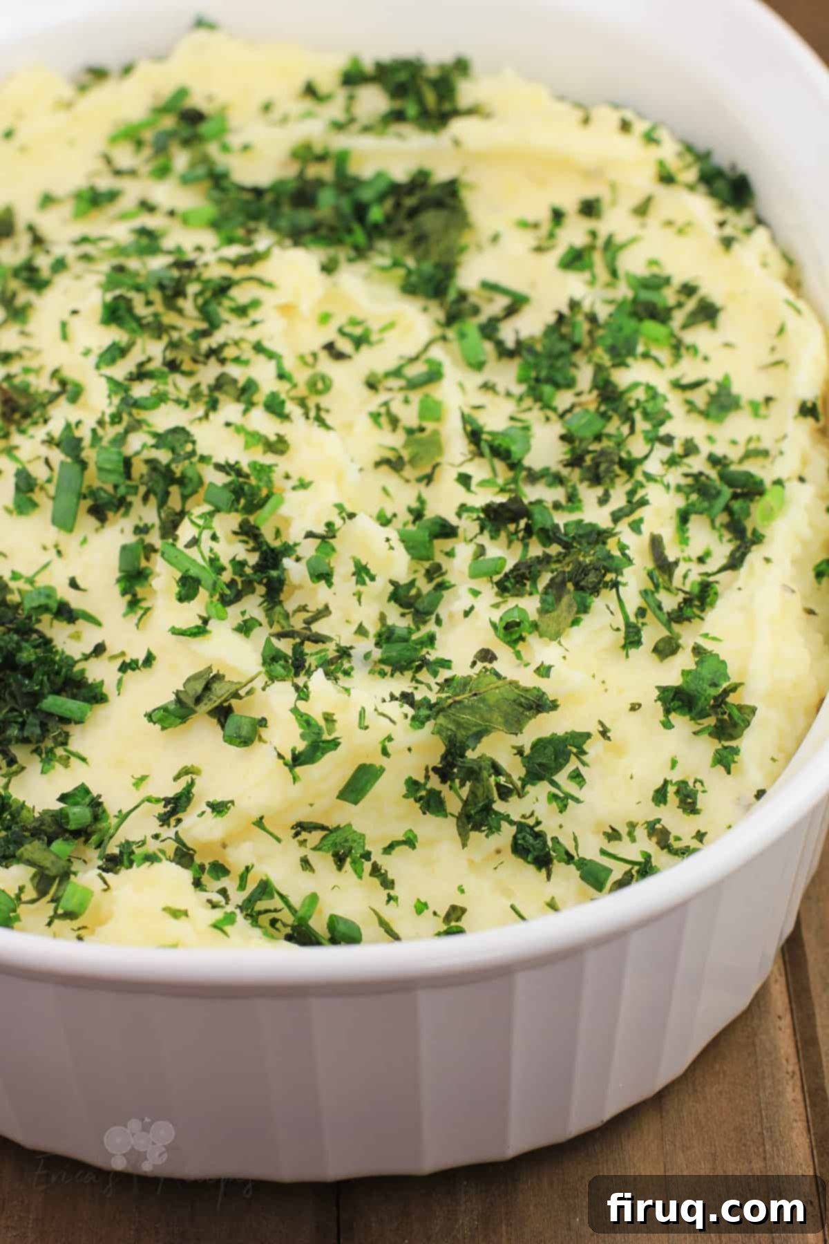 Decadent Boursin Mashed Potatoes 10 boursin mashed potatoes in white bake dish topped with herbs