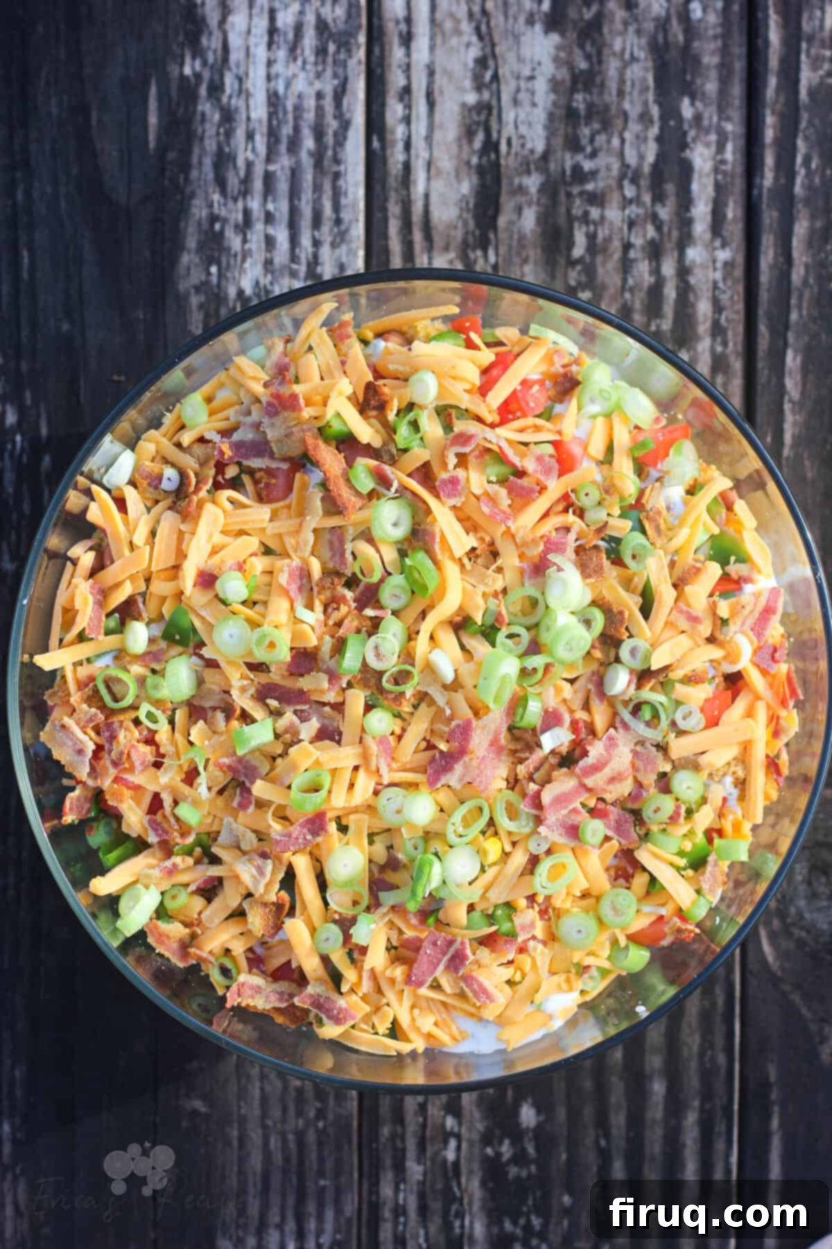 Southern Cornbread Layers 8 bowl of cornbread salad in clear glass bowl on weather wood table