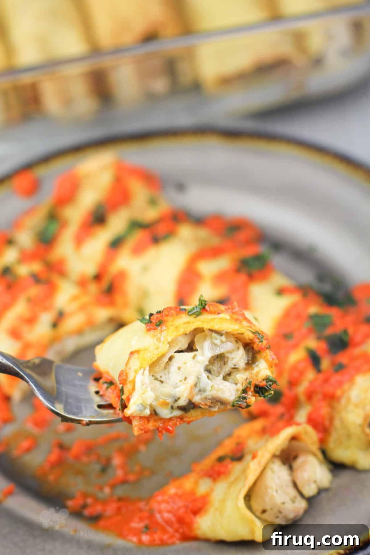 Savory Pesto Chicken Crepes 11 fork holding bite of crepe to show filling