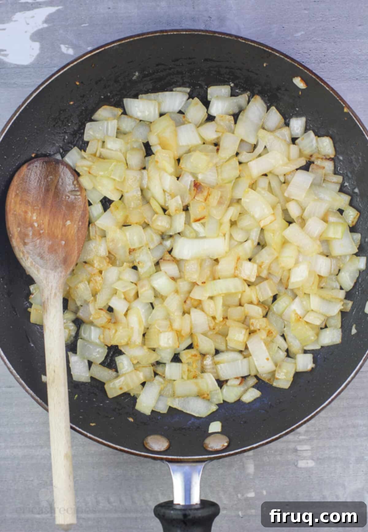Savory Pesto Chicken Crepes 4 onion and garlic in skillet with wood spoon