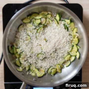 Creamy Zucchini Risotto 6 Arborio rice toasting in a saucepan with zucchini and shallots.