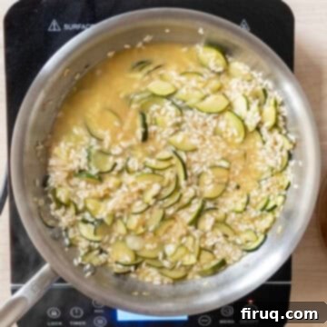 Creamy Zucchini Risotto 8 First ladleful of warm chicken broth added to the arborio rice mixture.