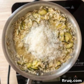 Creamy Zucchini Risotto 10 Saucepan off the heat with grated parmesan and fresh herbs added for finishing.