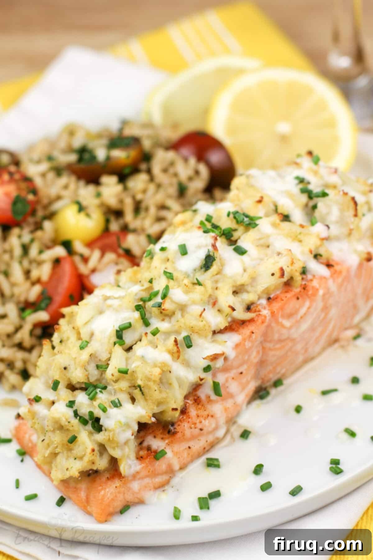 Gourmet Crab Stuffed Salmon 2 plated portion or salmon on white late with lemon and brown rice
