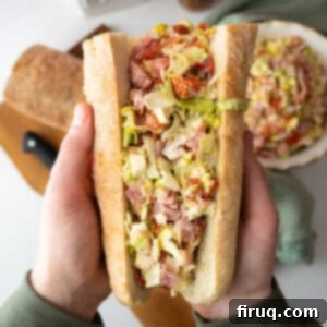 Chopped Italian Sub 9 Chopped Italian Salad in an Italian sub held by two hands.