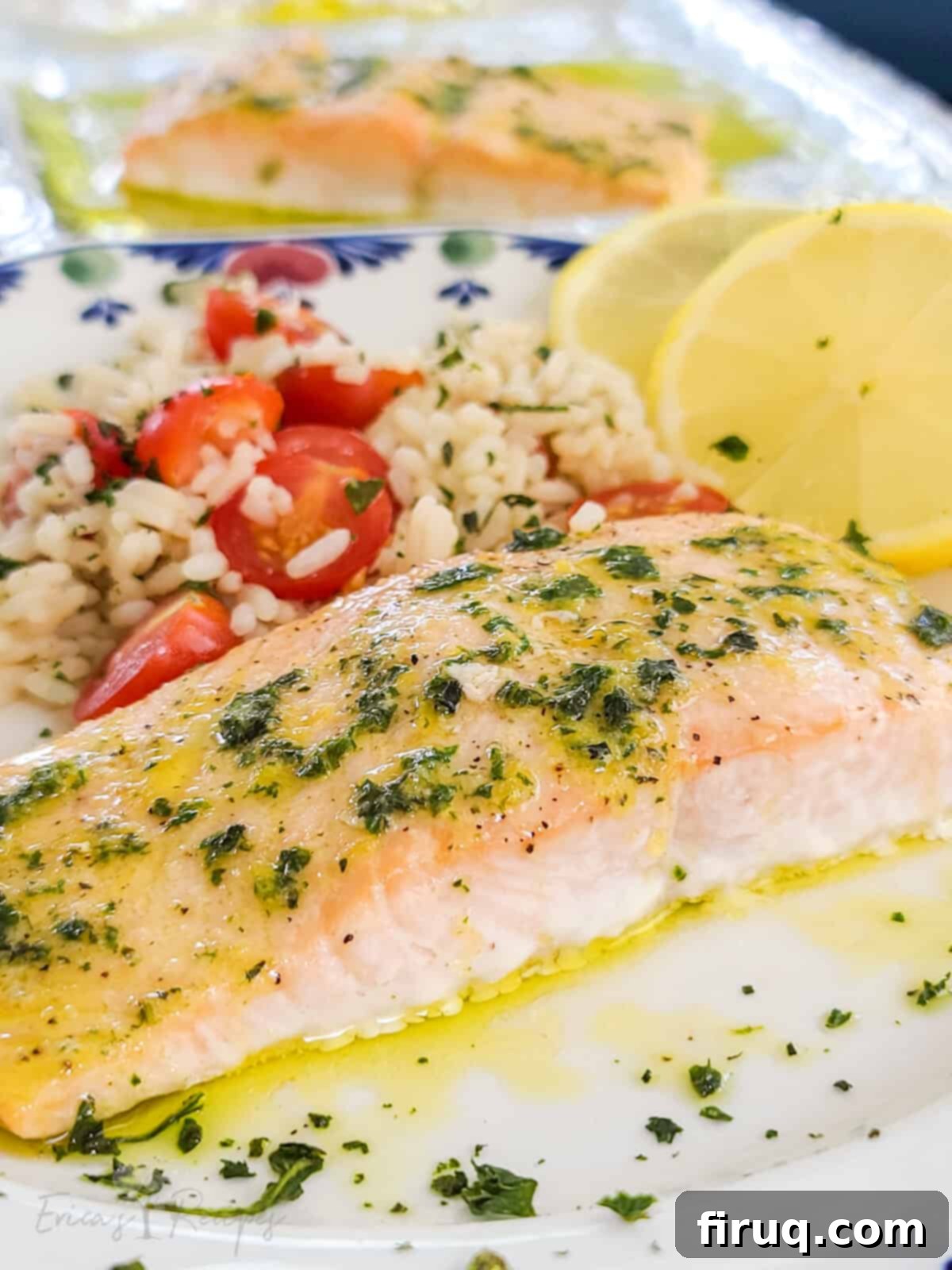 Easy Toaster Oven Salmon with Lemon Basil Butter 2 plated salmon topped with lemon basil butter on serving plate with rice and sliced lemon