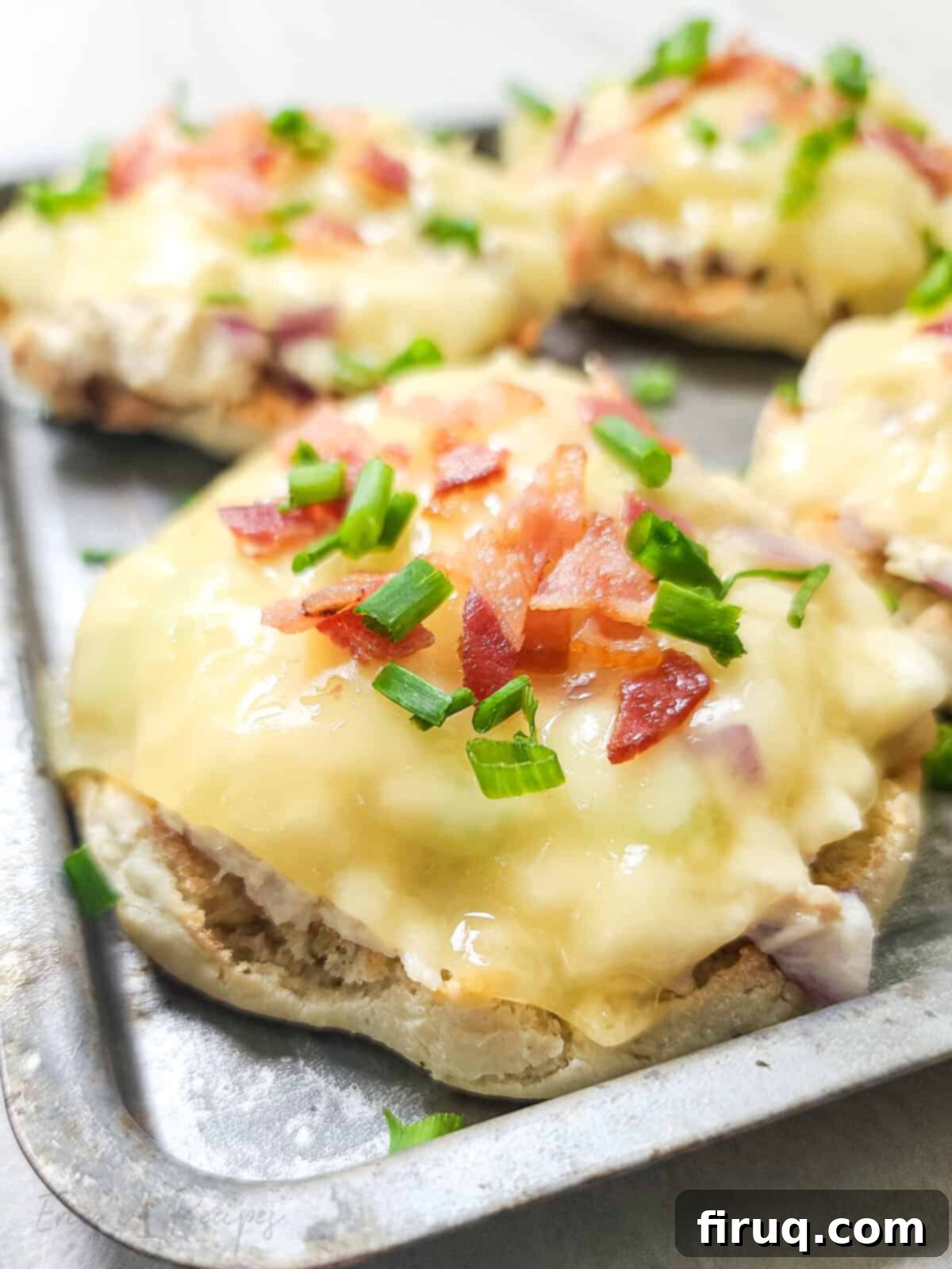 Crispy Bacon Tuna Melt 2 close, side view of open faced tuna melt on bake sheet topped with bacon and chives