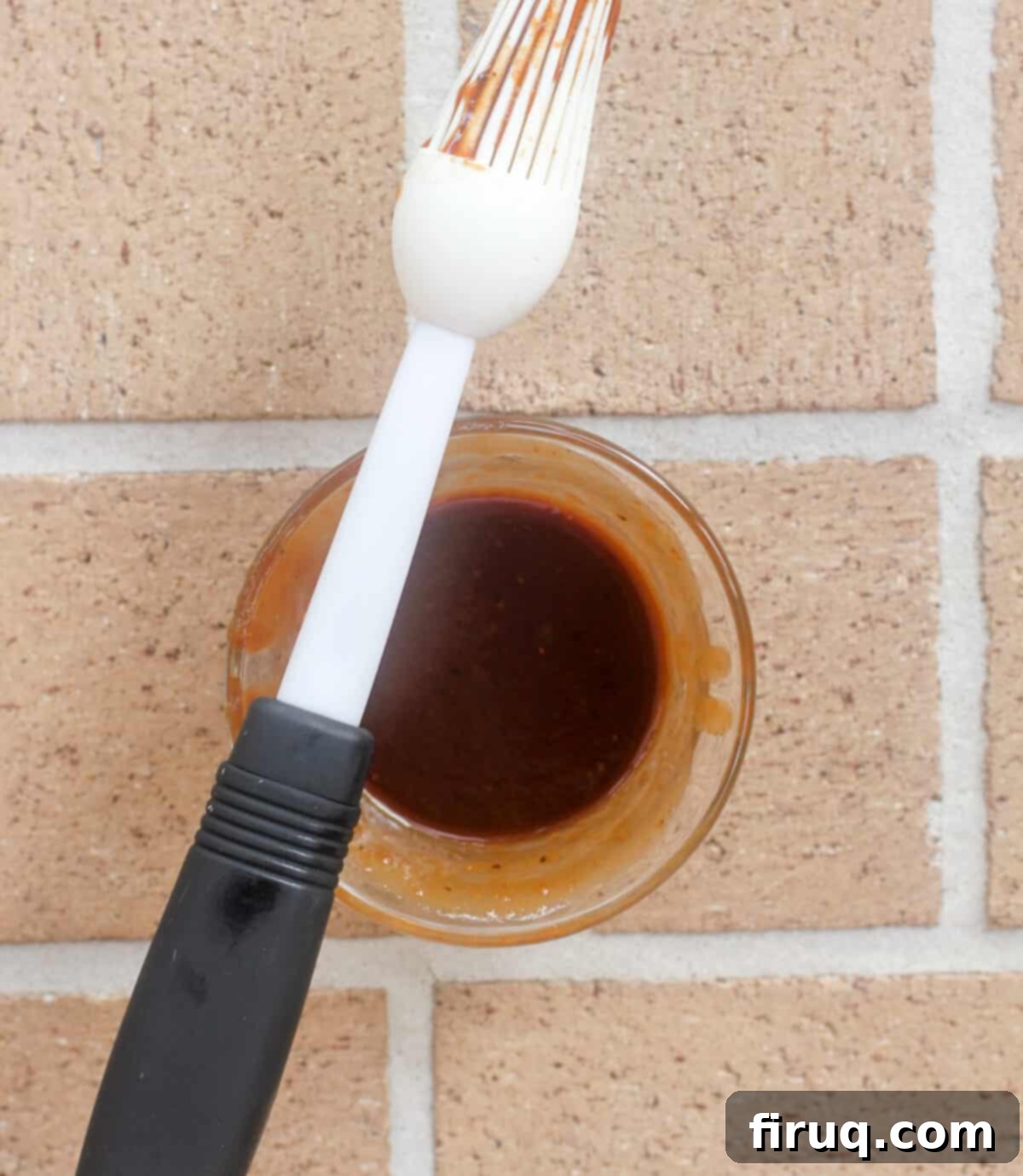 Smoked Bacon Wrapped Meat Log 7 small glass bowl with barbecue sauce; basting brush resting on bowl