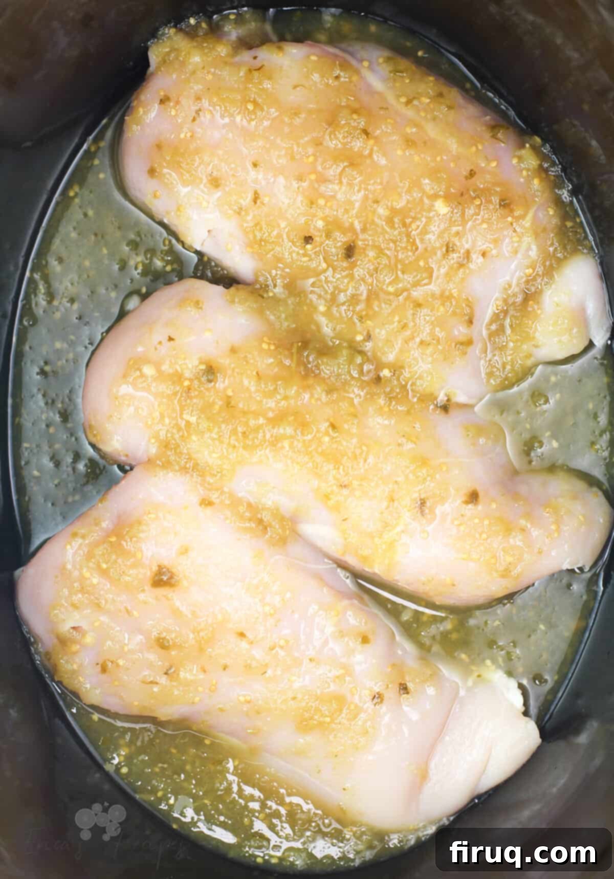 Easy 2-Ingredient Salsa Verde Chicken 3 raw chicken breasts in crock pot topped with salsa verde