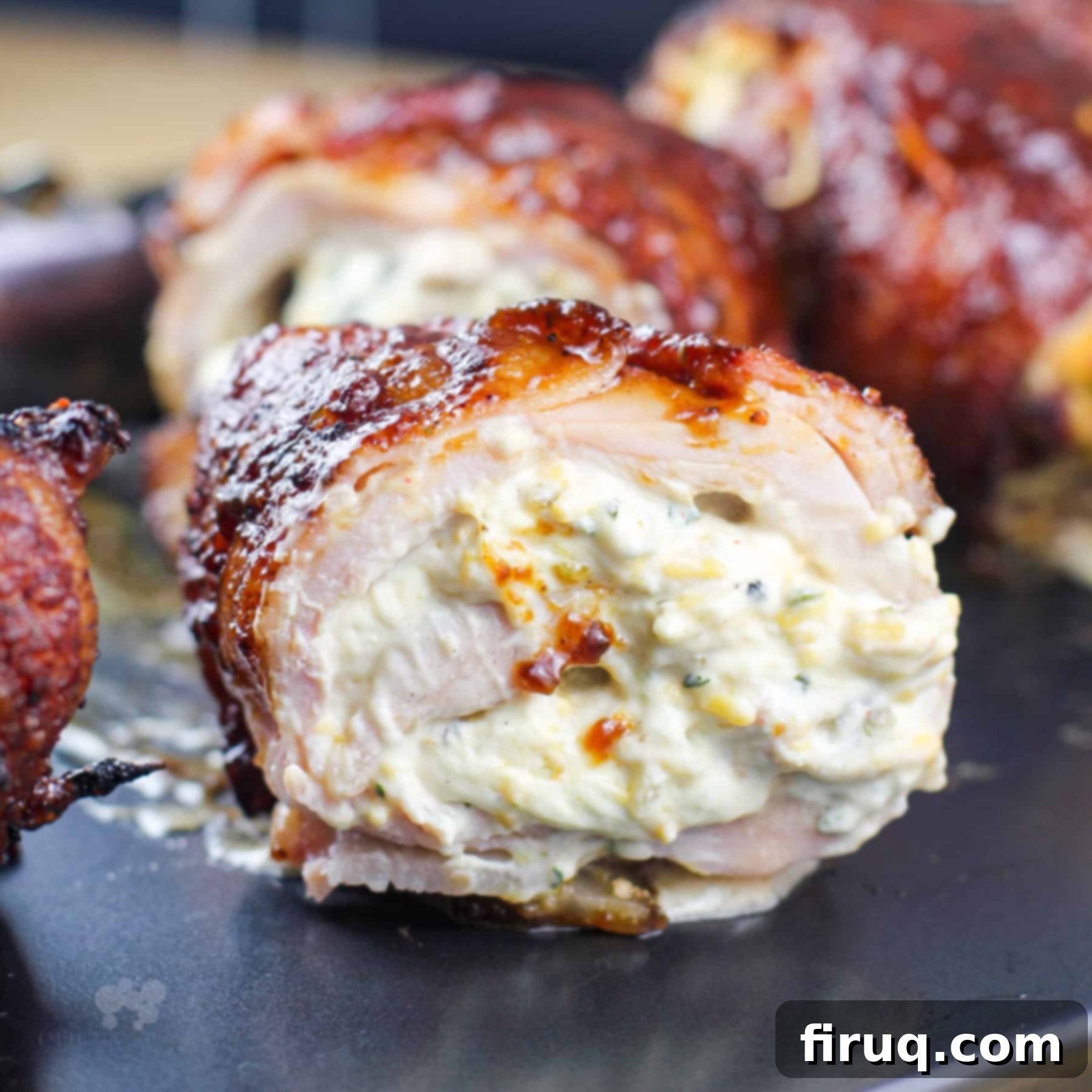 Smoky Jalapeno Chicken Poppers 7 Cross-section of a Smoked Jalapeno Stuffed Chicken Bomb, showcasing the melted cheese and tender chicken.