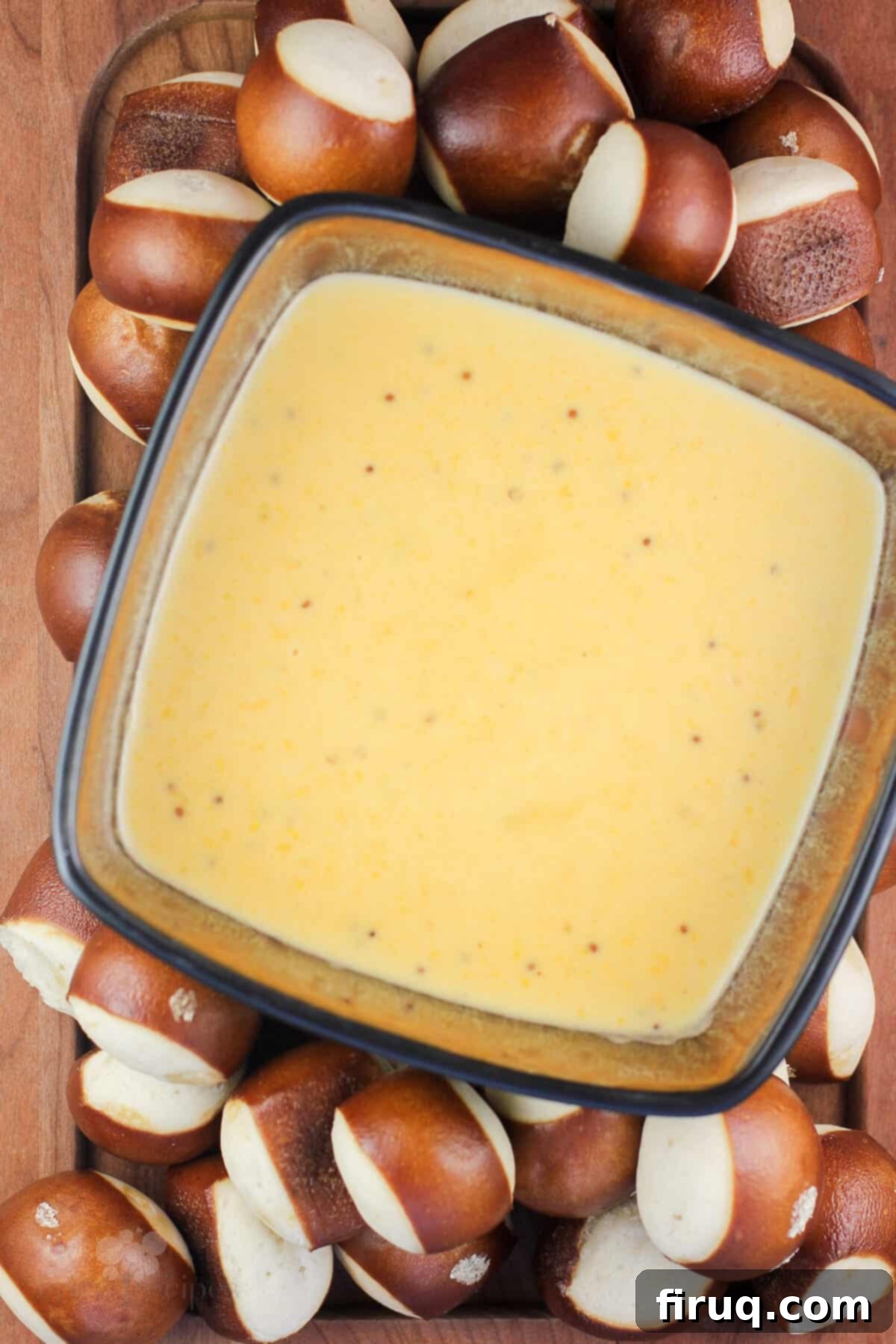Traditional German Beer Cheese 3 wood platter with bowl of german beer cheese surrounded by pretzel bread bites