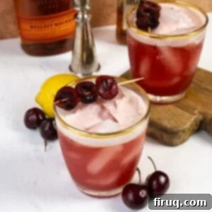 Crimson Amaretto Sour 5 A Cherry Amaretto Sour in a glass with a cherry garnish and a foamy top, ready to be enjoyed.