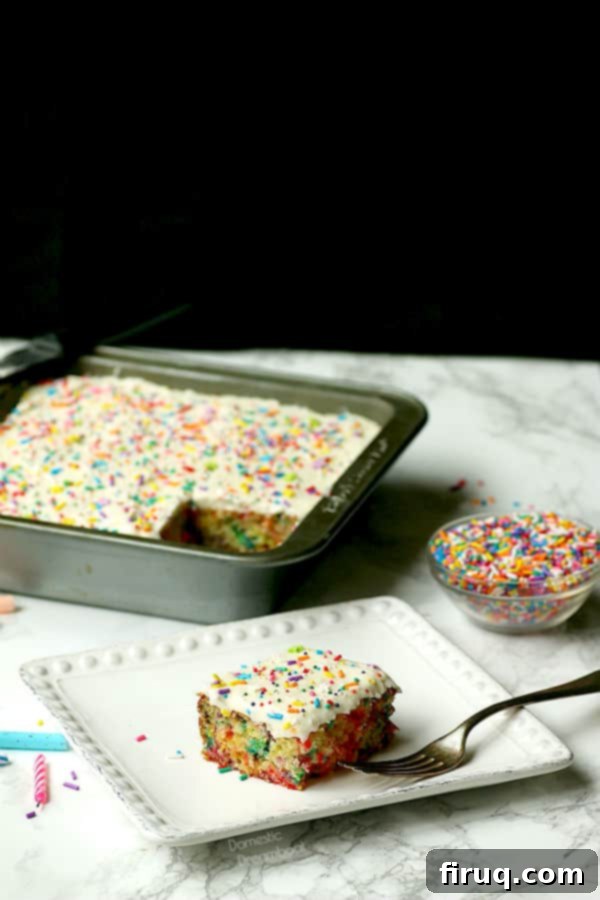 Super Easy Sprinkle Cake Frosted Close-up of the perfectly frosted and sprinkled easy sprinkle cake, showcasing the smooth vanilla buttercream and bright jimmies.