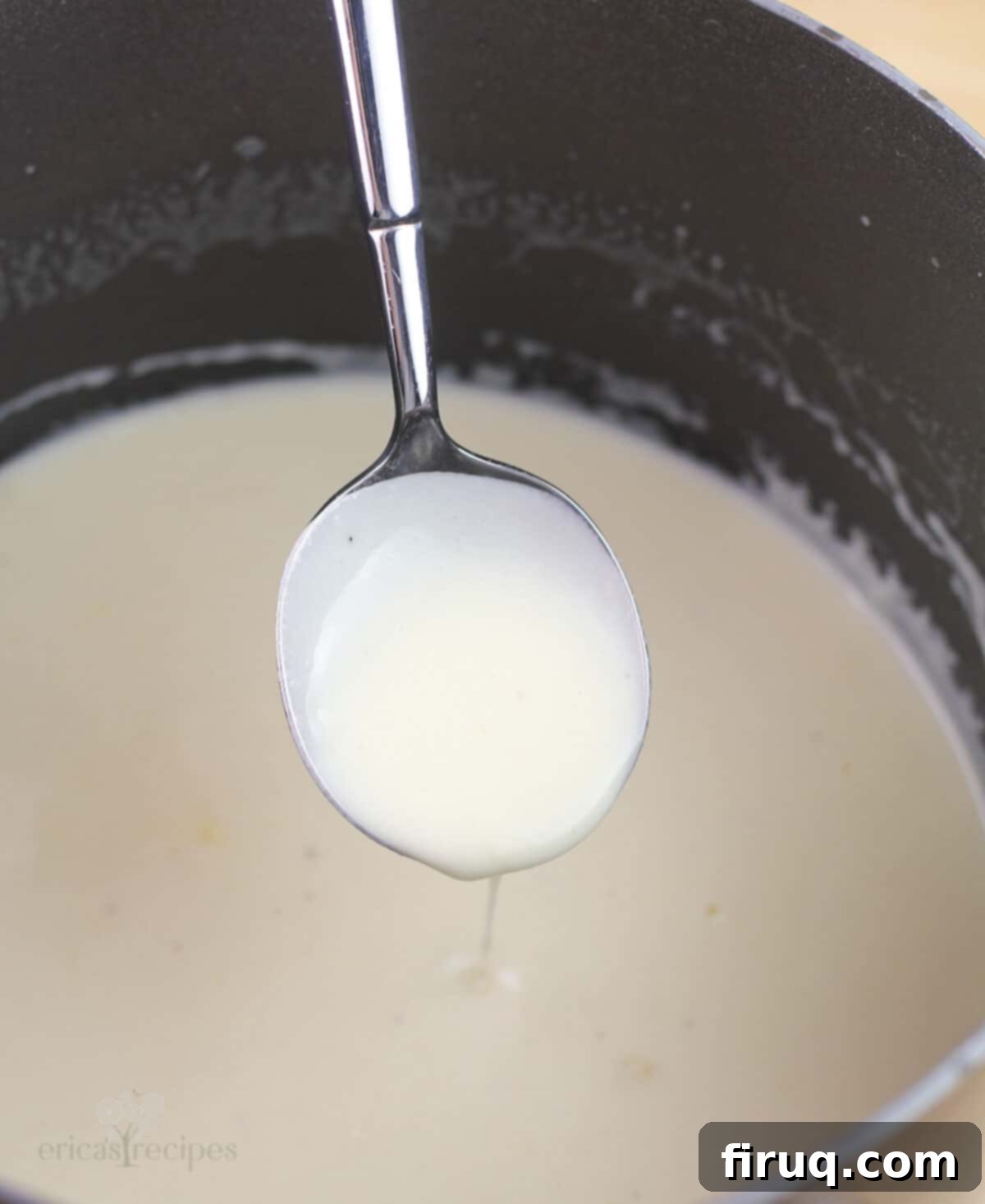 Sweet & Savory Sausage Crepes with Maple Béchamel 4 spoon holding maple bechamel to show thickened consistency