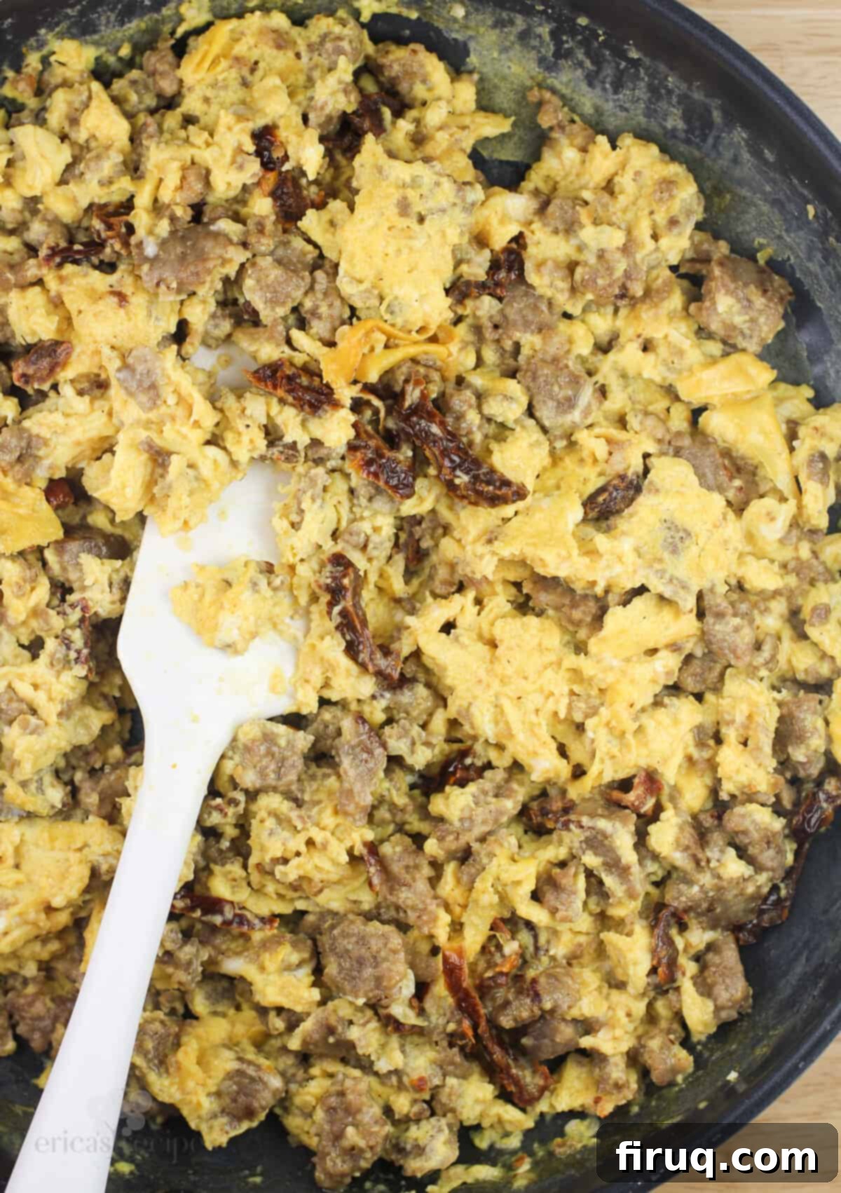 Sweet & Savory Sausage Crepes with Maple Béchamel 5 egg and sausage crepe filling in skillet with white rubber spatula