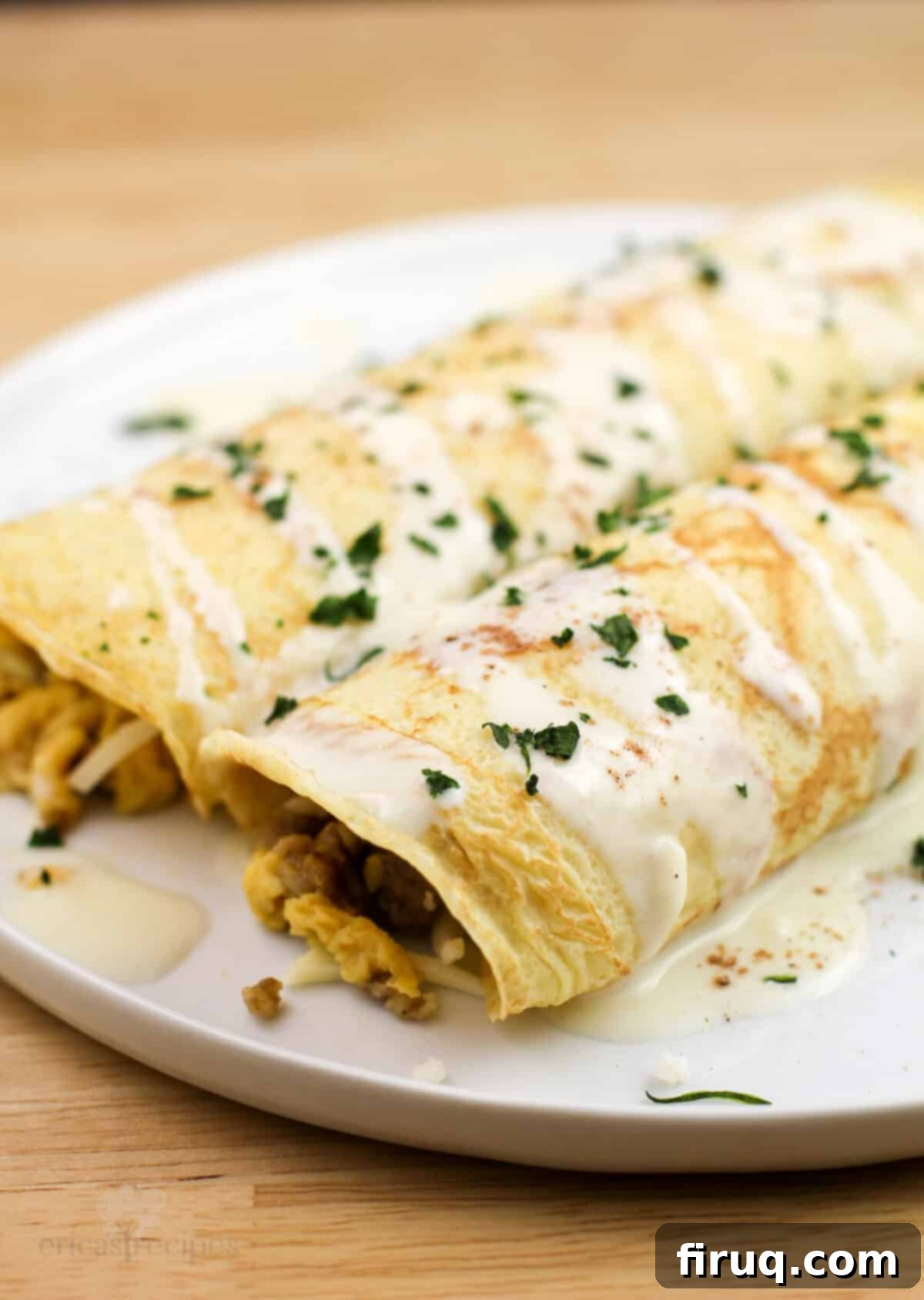 Sweet & Savory Sausage Crepes with Maple Béchamel 8 two assembled crepes on white plate