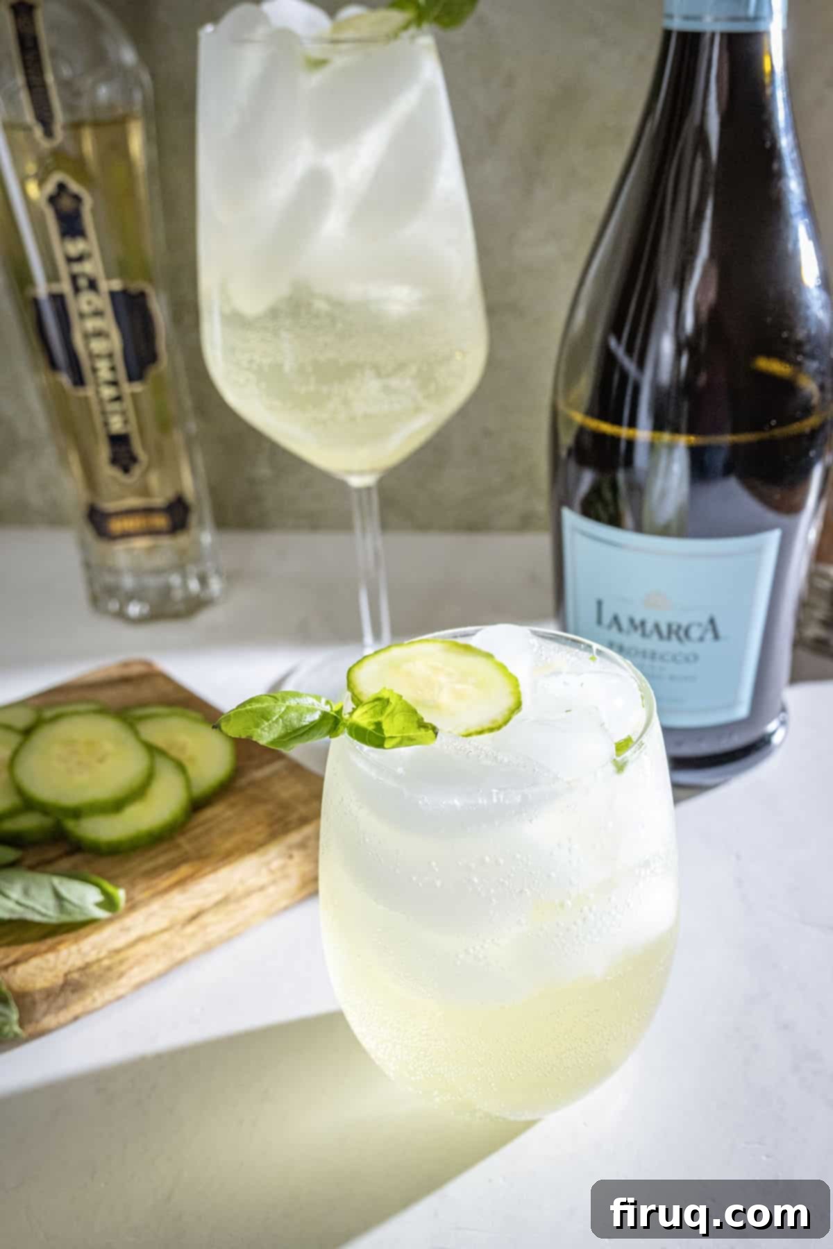 St Germain Basil Cucumber Cooler 2 St germain spritz with cucumber and basil garnish.