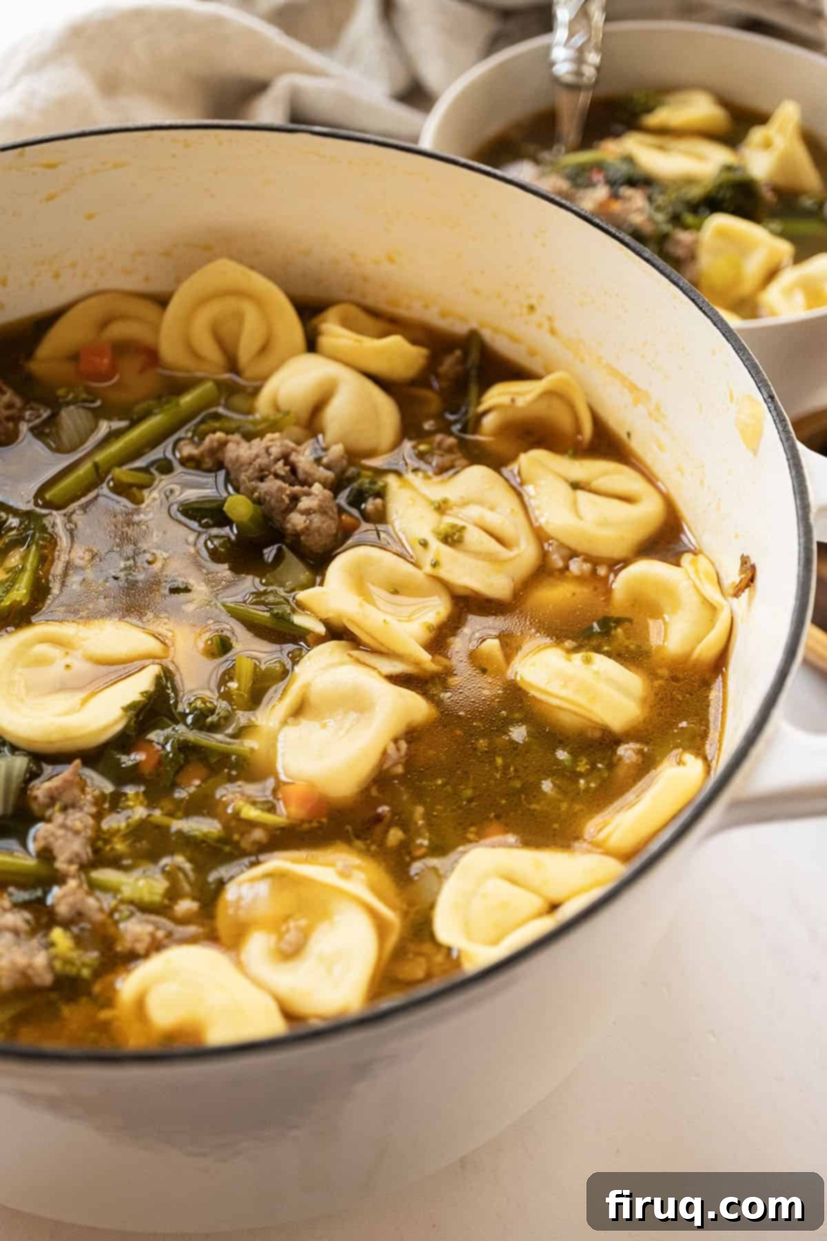 Savory Broccoli Rabe & Tortellini Bowl 2 A large Dutch oven filled with rich Sausage and Broccoli Rabe Soup with Tortellini, ready to be served.