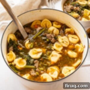 Savory Broccoli Rabe & Tortellini Bowl 12 A large Dutch oven filled with hearty Sausage and Broccoli Rabe Soup with Tortellini, garnished with fresh herbs and Parmesan.