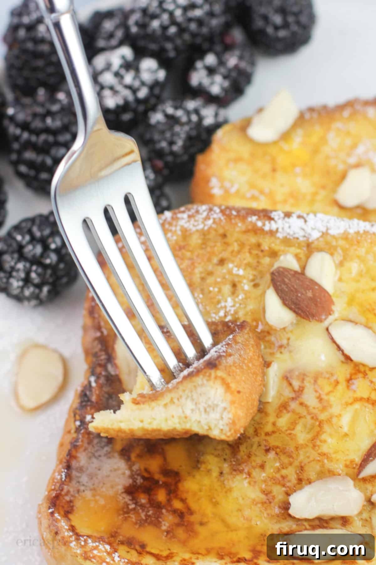 Blackstone Amaretto French Toast 8 A fork piercing a piece of Amaretto French toast, highlighting its fluffy interior and ready-to-eat appeal.