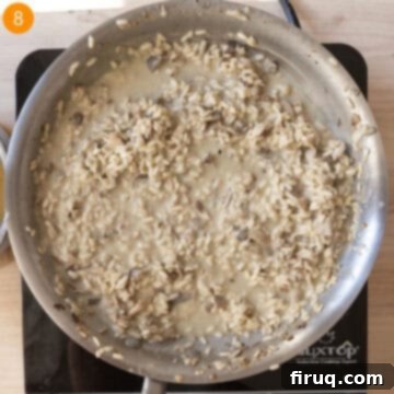 Mushroom Gorgonzola Risotto 11 Risotto being tossed with melted gorgonzola and butter in a pan, creating a creamy texture.