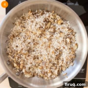 Mushroom Gorgonzola Risotto 7 Arborio rice being toasted in a pan with sautéed mushrooms and shallots.