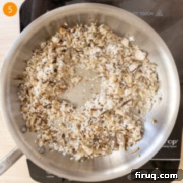 Mushroom Gorgonzola Risotto 8 White wine being poured into the pan to deglaze the rice and vegetables.