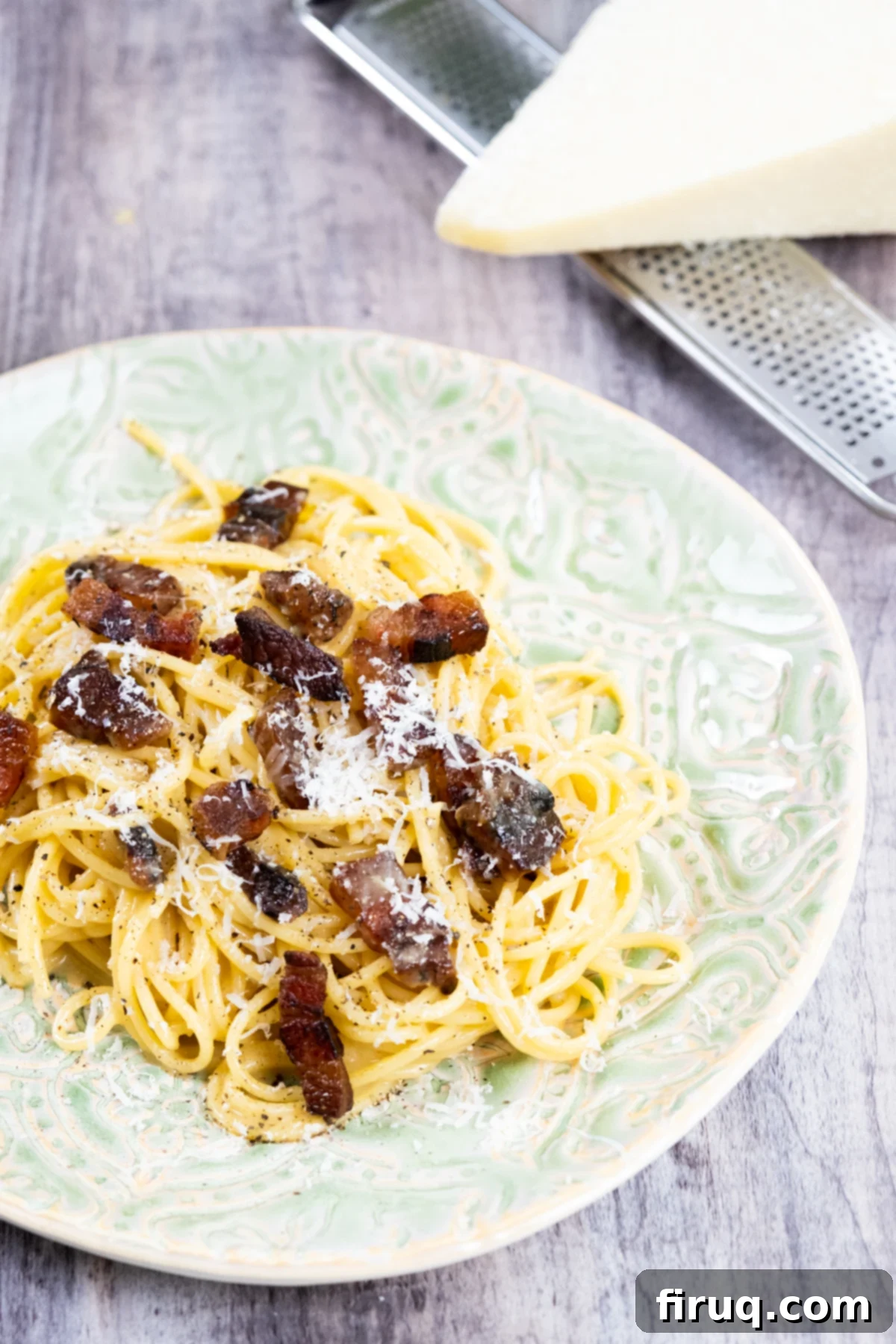 The Ultimate Carbonara Do's and Don'ts 12 Close-up of Spaghetti Carbonara showcasing its creamy sauce, crispy guanciale, and abundant Pecorino Romano.