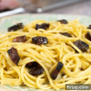 The Ultimate Carbonara Do's and Don'ts 17 Burnt guanciale in a pan, a common carbonara mistake.