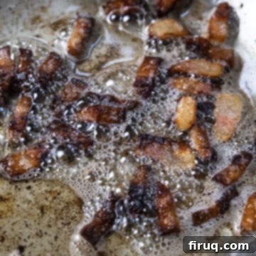 The Ultimate Carbonara Do's and Don'ts 5 Guanciale slowly frying in its own rendered fat in a saucepan.
