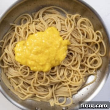 The Ultimate Carbonara Do's and Don'ts 9 The egg and cheese mixture being vigorously stirred into the hot spaghetti.